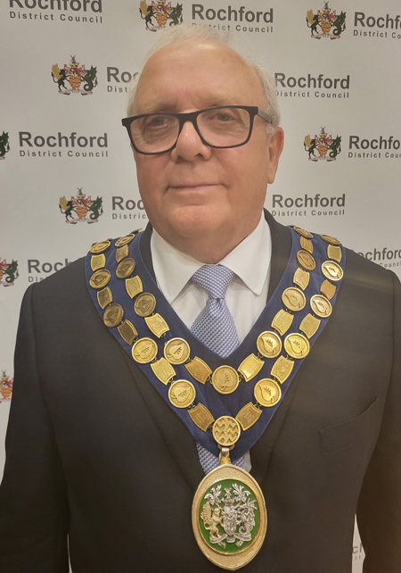 Cllr Jack Lawmon wearing a suit and ceremonial chain