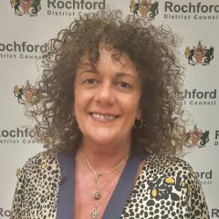 Cllr Sarah Jane Page standing in front of a Rochford District Council branded backdrop